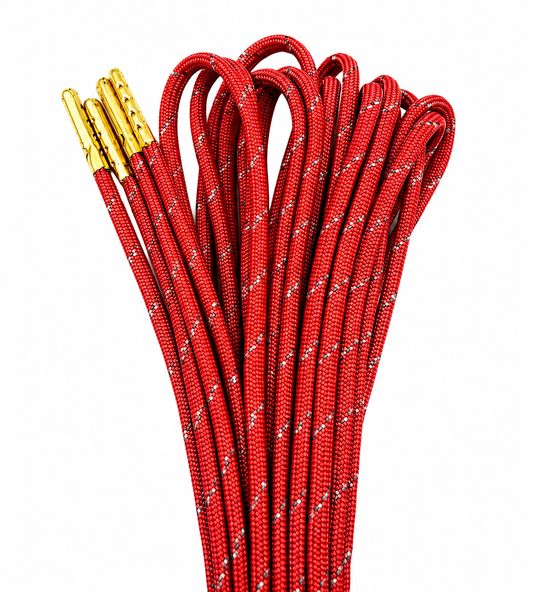 Red paracord skate laces with gold metal aglets against a solid white background.