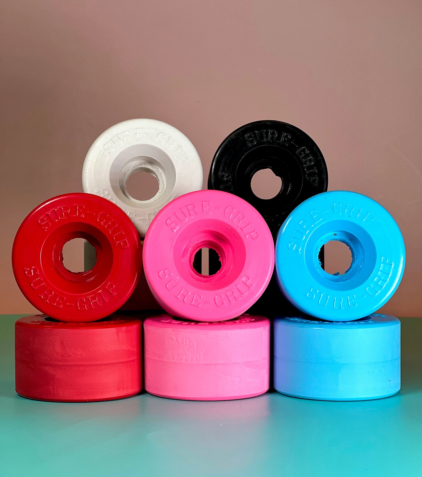 Colorful roller skate wheels stacked on a gradient background