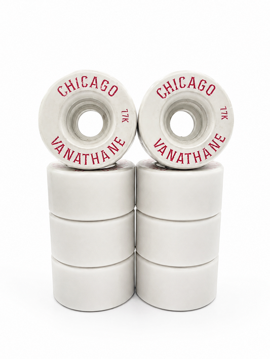 Six white skateboard wheels stacked in two columns of three, with two wheels on top showing red printed text that reads 'CHICAGO' and 'VANATHANE'.
